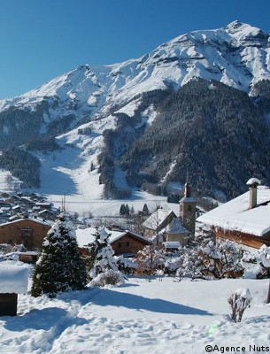 pretty chalets covered with snow in les-contamines ski resort